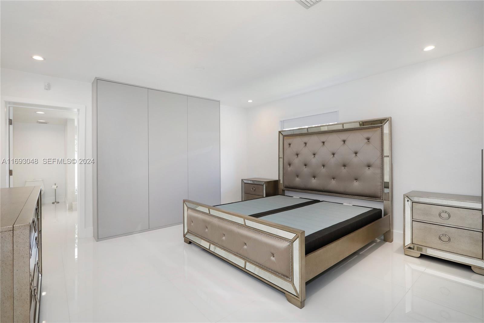 9611 Southwest 59th Terrace Miami, FL 33173 - Photo 14 of 32 a bedroom with a bed and cabinet