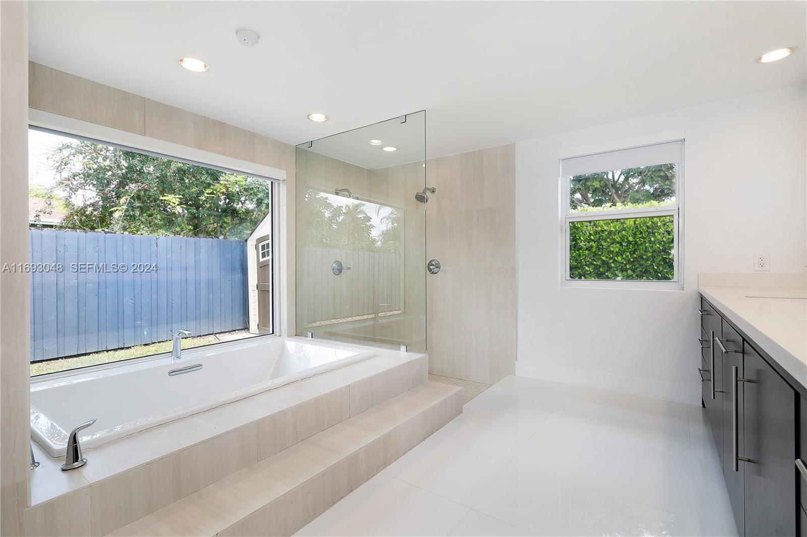 9611 Southwest 59th Terrace Miami, FL 33173 - Photo 18 of 32 a bathroom with a sink and a large mirror