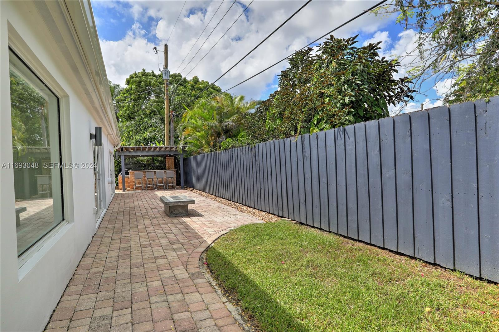 9611 Southwest 59th Terrace Miami, FL 33173 - Photo 25 of 32 a backyard of a house with table and chairs and wooden fence