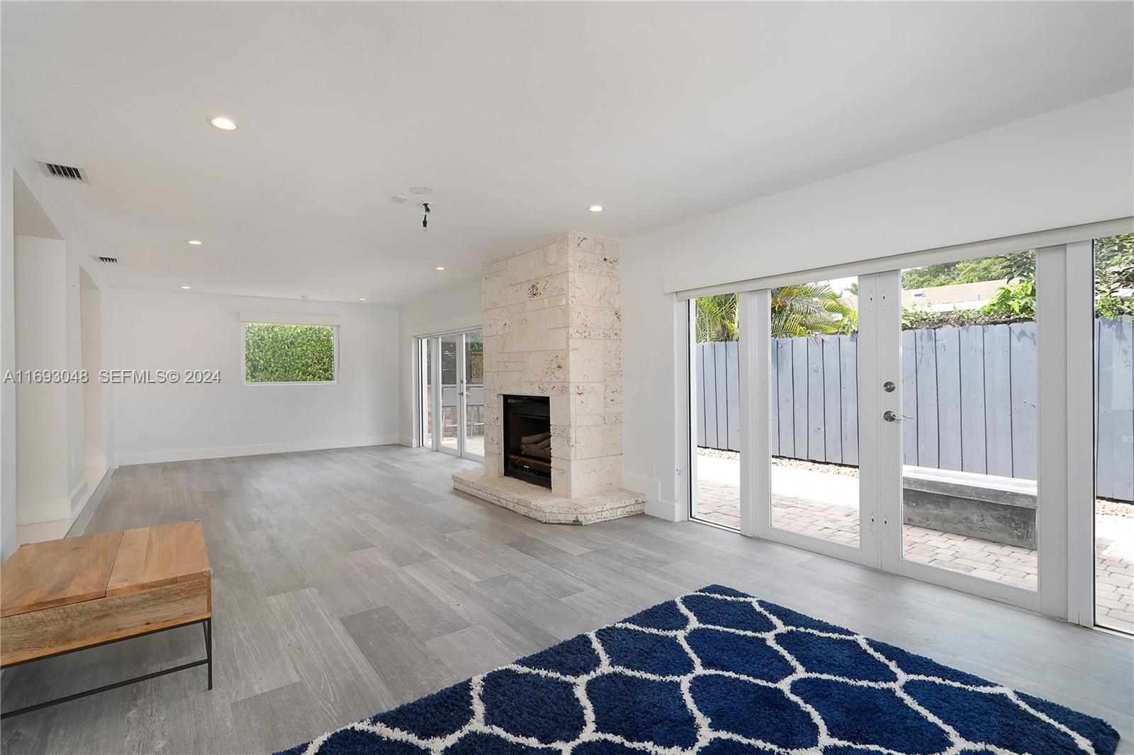 9611 Southwest 59th Terrace Miami, FL 33173 - Photo 7 of 32 a view of an empty room with a fireplace and a window