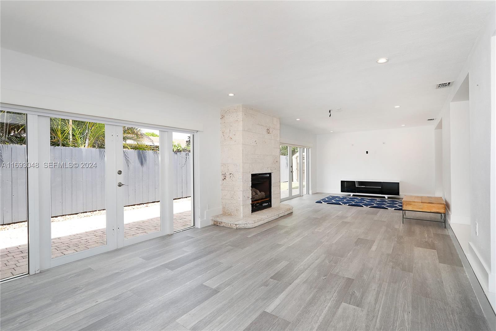 9611 Southwest 59th Terrace Miami, FL 33173 - Photo 9 of 32 a view of a livingroom with wooden floor and fireplace