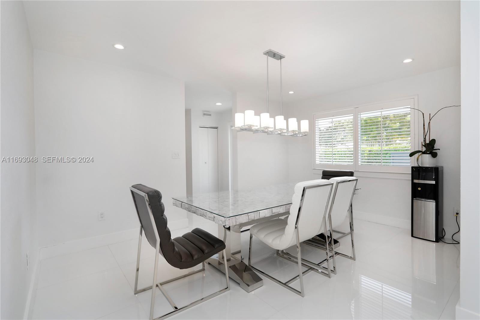9611 Southwest 59th Terrace Miami, FL 33173 - Photo 10 of 32 a view of a dining room with furniture and chandelier
