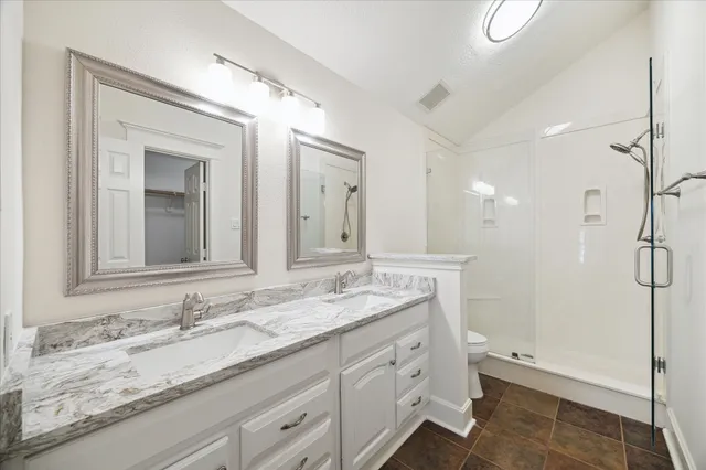 a bedroom with a bed and a chandelier fan