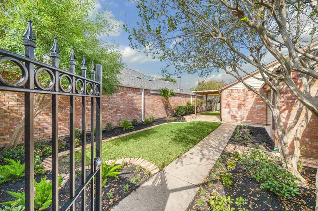 a view of a house with backyard and sitting area