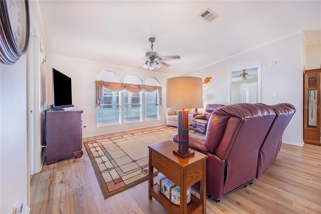 332 Fairway Boulevard Frostproof, FL 33843 - Photo 13 of 56 a living room with furniture a flat screen tv and a fireplace