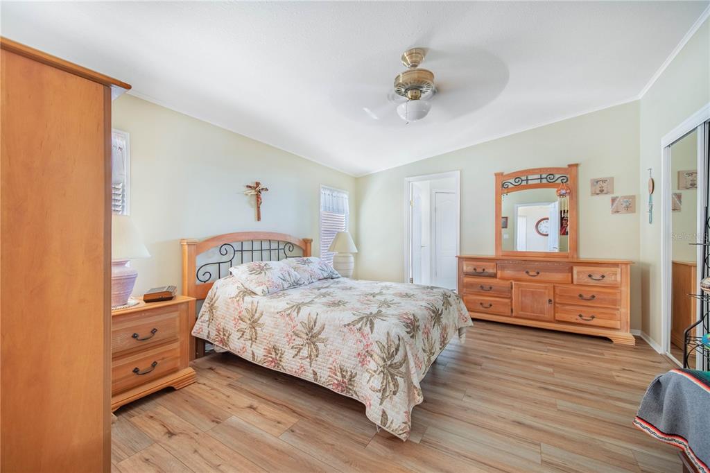 332 Fairway Boulevard Frostproof, FL 33843 - Photo 20 of 56 a bedroom with a bed and wooden floor