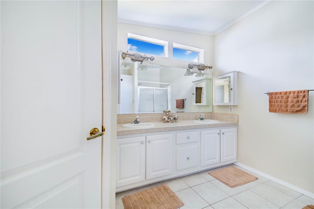 332 Fairway Boulevard Frostproof, FL 33843 - Photo 22 of 56 a spacious bathroom with a mirror and a sink