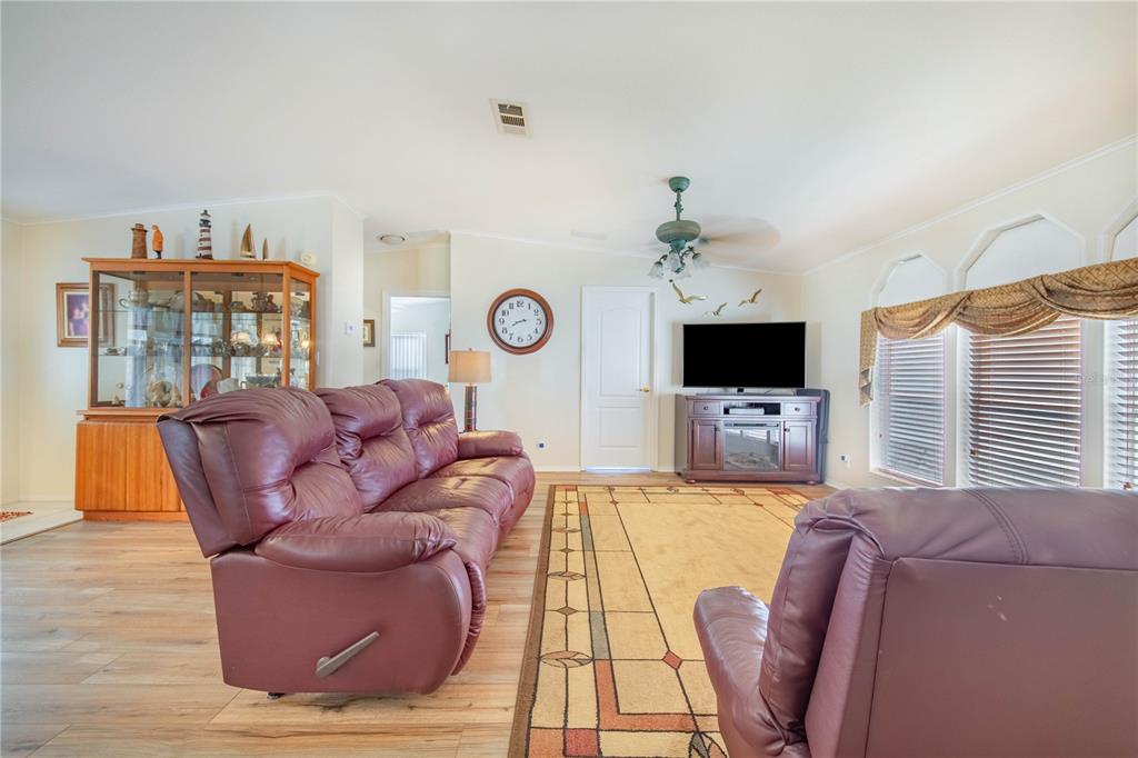 332 Fairway Boulevard Frostproof, FL 33843 - Photo 24 of 56 a living room with furniture a flat screen tv and a window
