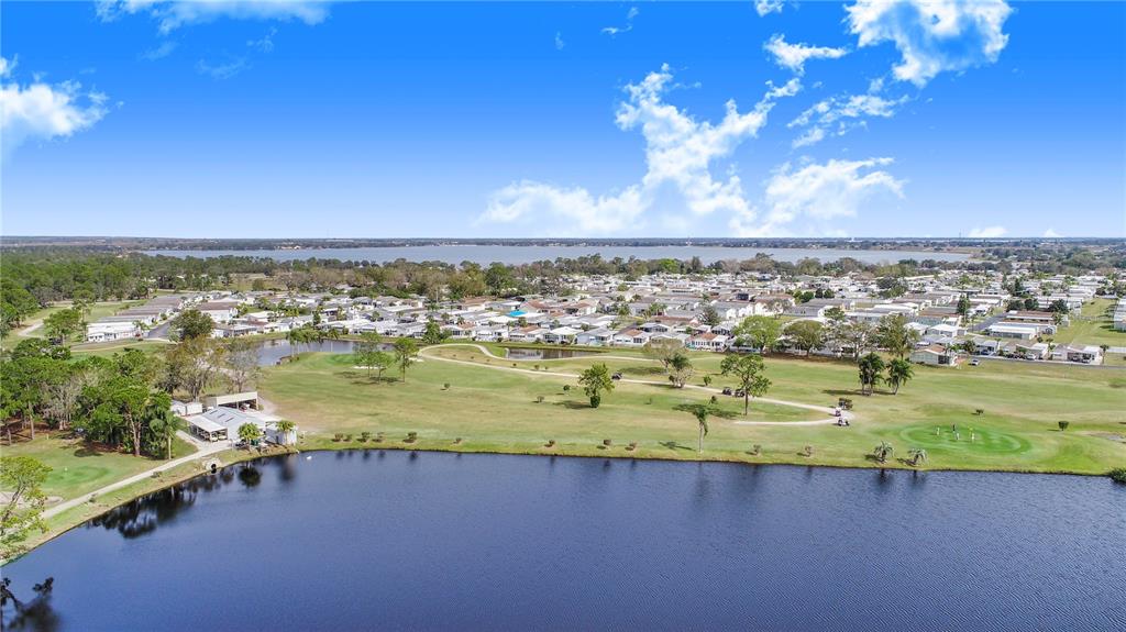 332 Fairway Boulevard Frostproof, FL 33843 - Photo 45 of 56 a view of a lake with a city