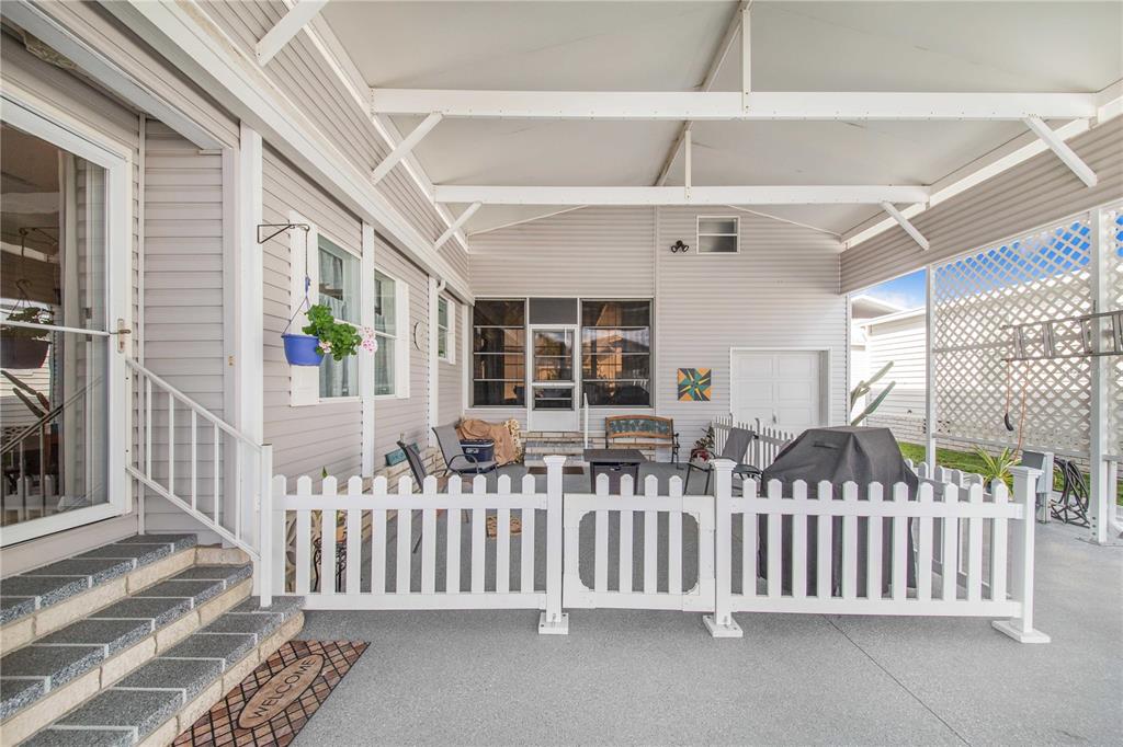 332 Fairway Boulevard Frostproof, FL 33843 - Photo 8 of 56 a view of a porch with wooden floor and fence