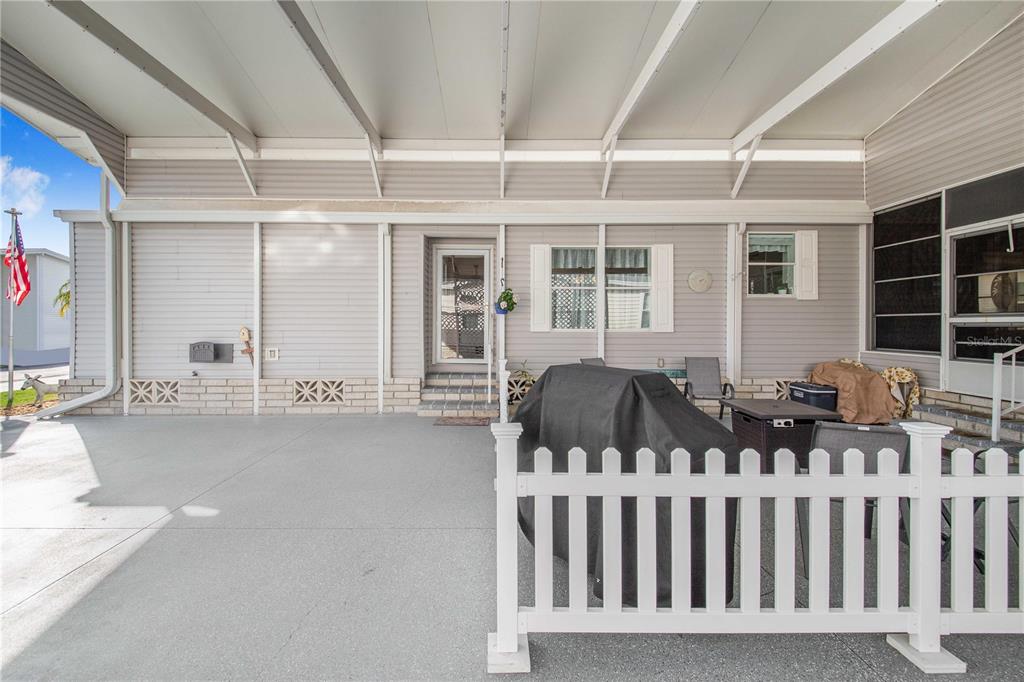 332 Fairway Boulevard Frostproof, FL 33843 - Photo 9 of 56 a view of a house with two chairs and a porch