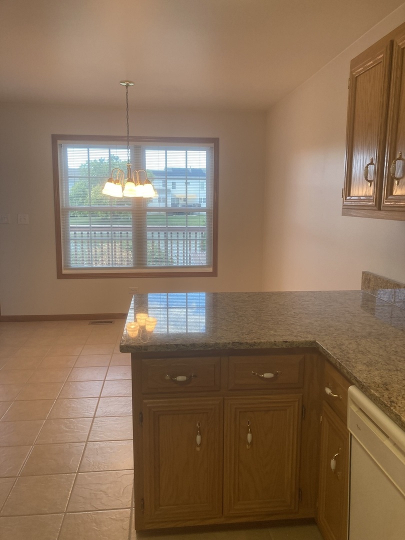 Undisclosed Address Joliet, IL 60435 - Photo 6 of 20 a kitchen with a sink a counter top space and a window