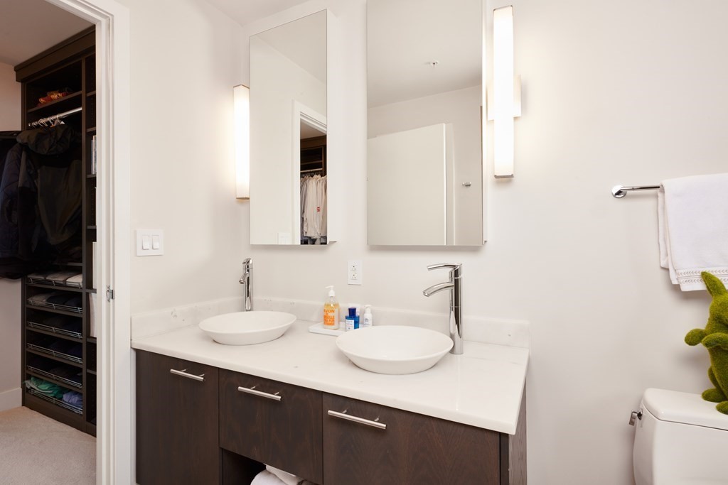 110 Stuart Street, Unit 26F Boston, MA 02116 - Photo 14 of 24 a bathroom with a sink and a mirror