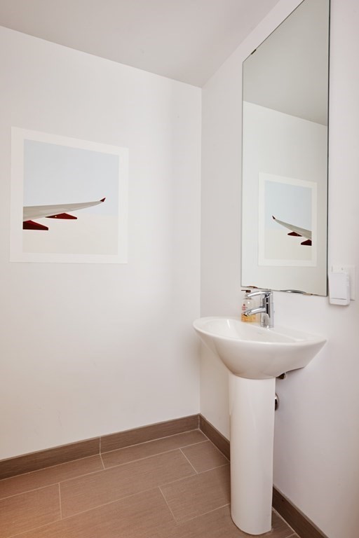110 Stuart Street, Unit 26F Boston, MA 02116 - Photo 16 of 24 a bathroom with a sink a mirror and a toilet