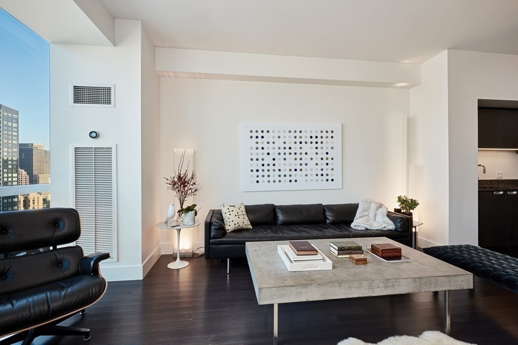 110 Stuart Street, Unit 26F Boston, MA 02116 - Photo 3 of 24 a living room with furniture and a wooden floor