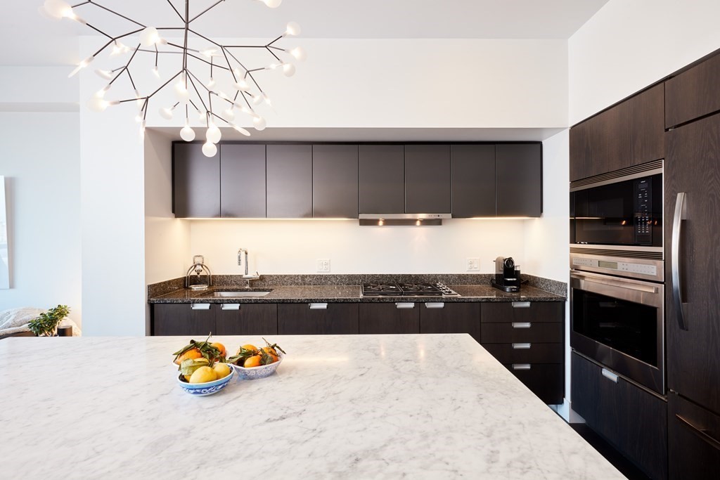 110 Stuart Street, Unit 26F Boston, MA 02116 - Photo 8 of 24 a kitchen with a sink a stove and cabinets