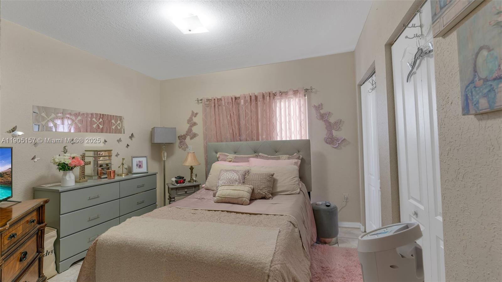 2993 West 80th Street, Unit 29 Hialeah, FL 33018 - Photo 14 of 21 a bedroom with a bed and a window