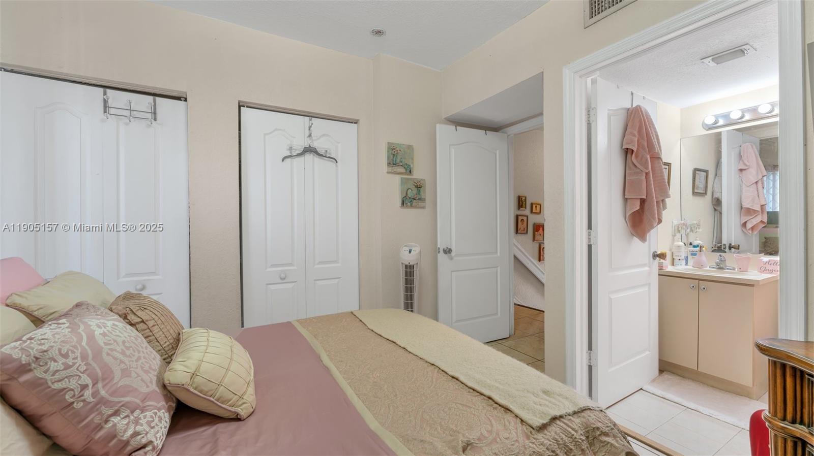 2993 West 80th Street, Unit 29 Hialeah, FL 33018 - Photo 16 of 21 a bedroom with a bed and a mirror