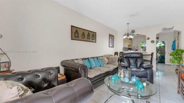 a living room with furniture and a dining table