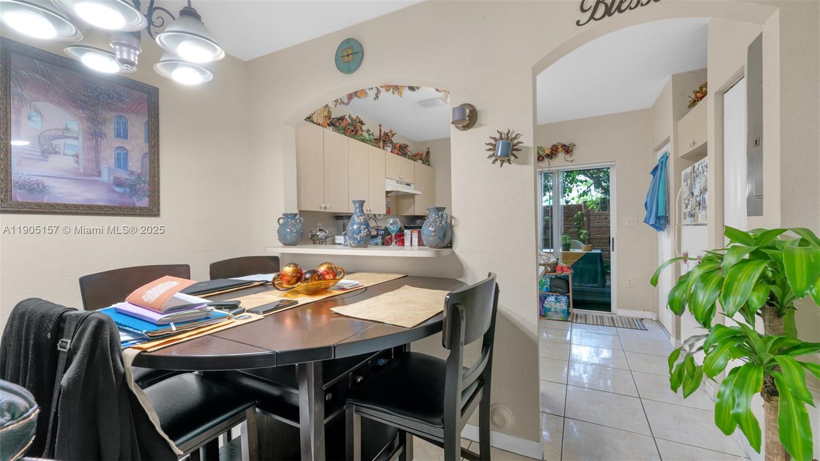 2993 West 80th Street, Unit 29 Hialeah, FL 33018 - Photo 4 of 21 a view of a dining room with furniture and chandelier