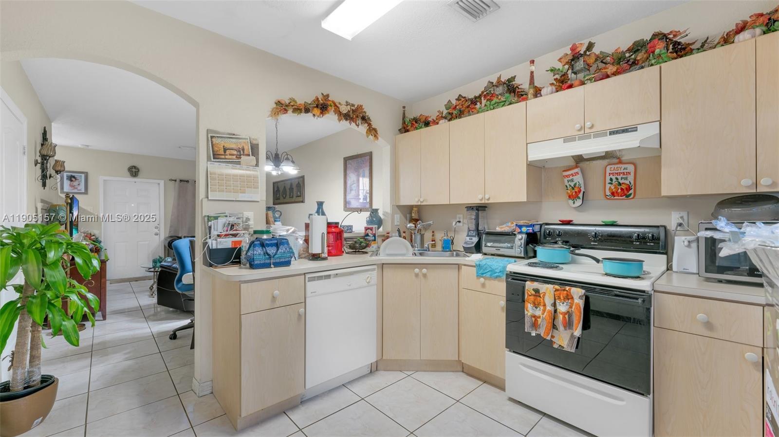 2993 West 80th Street, Unit 29 Hialeah, FL 33018 - Photo 6 of 21 a kitchen with white cabinets and white appliances