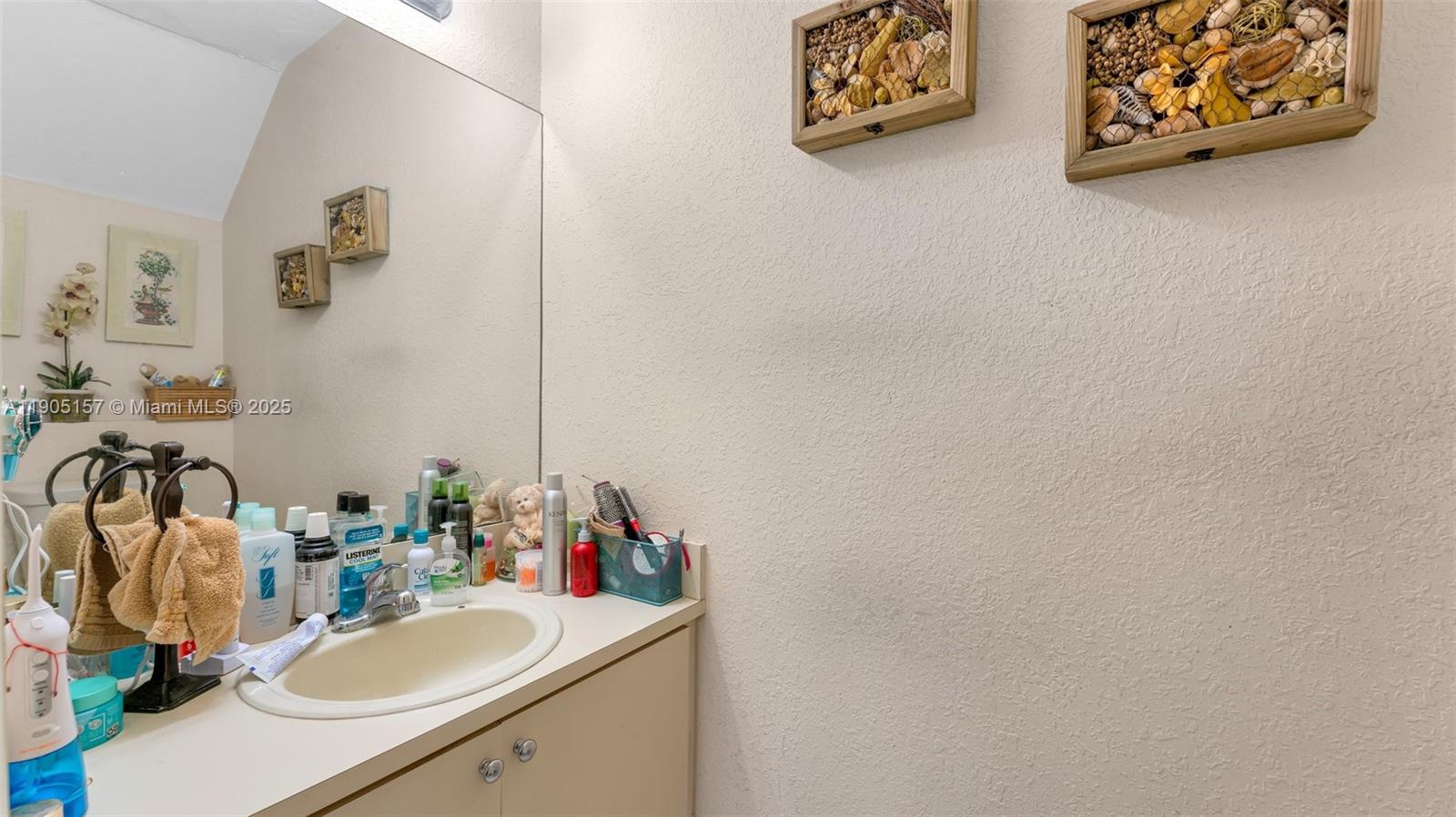 2993 West 80th Street, Unit 29 Hialeah, FL 33018 - Photo 10 of 21 a bathroom with a sink and a mirror