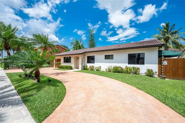 a front view of house with a garden