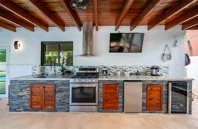 a kitchen with stainless steel appliances granite countertop a stove and a sink