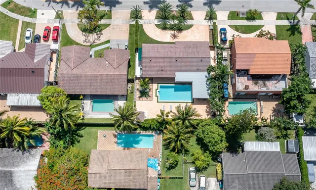 an aerial view of houses with yard