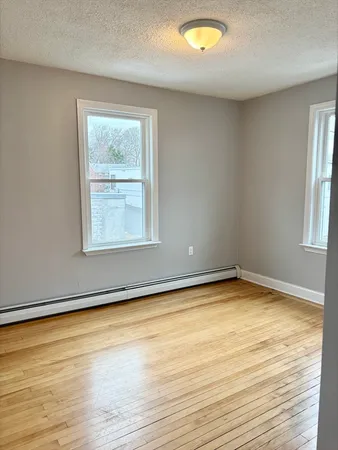 a view of a room with wooden floor and window