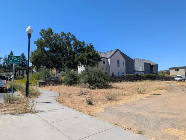 a view of large house with a snow on the road