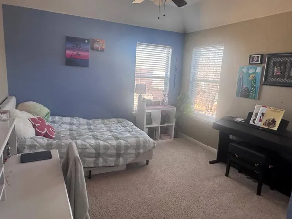 a bedroom with a bed and a window