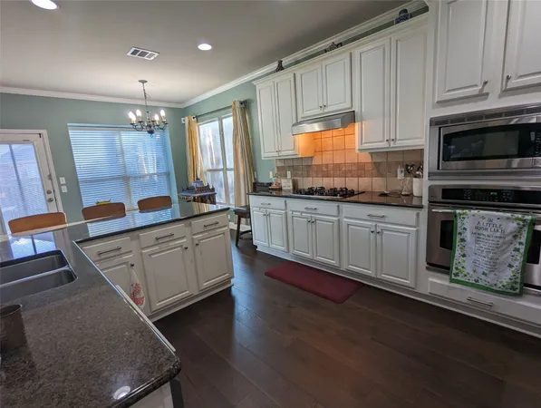 a kitchen with sink cabinets and window