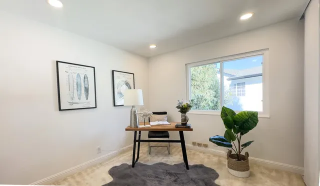 a view of a livingroom with wooden floor and a window