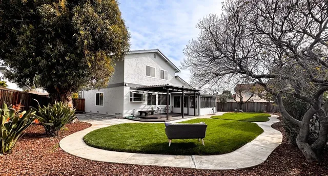 a front view of a house with a yard table and chairs