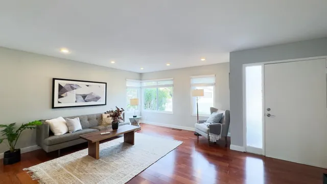 a large kitchen with stainless steel appliances granite countertop a sink stove and refrigerator