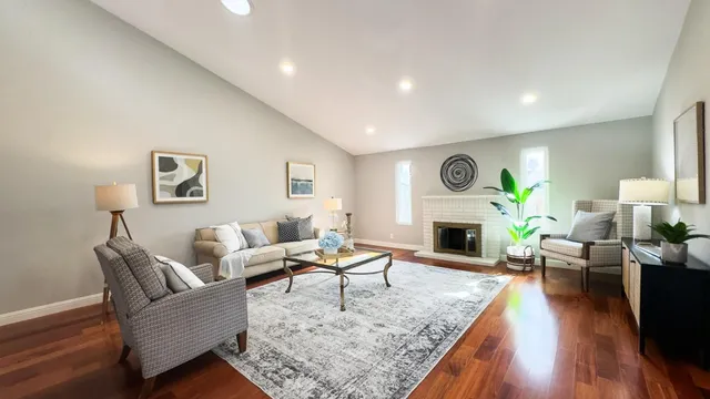 a living room with furniture and a fireplace