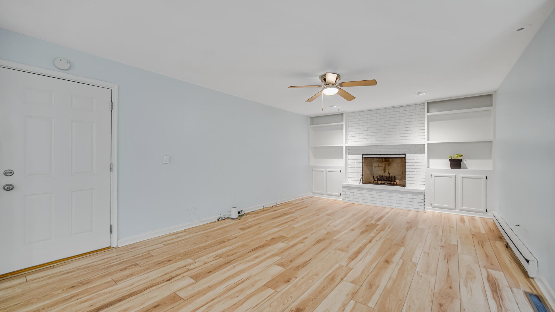 6717 State Rte 49 Rensselaer, IN 47978 - Photo 16 of 31 a view of empty room with wooden floor and fireplace