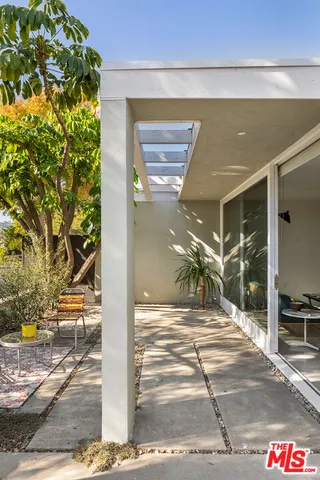 a view of a patio with table and chairs and potted plants