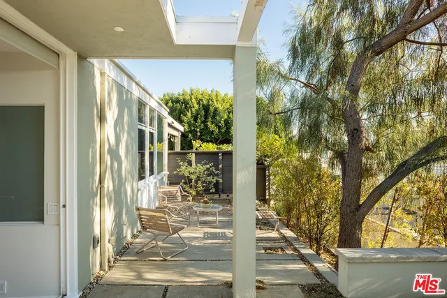 a view of backyard with swimming pool and sitting area