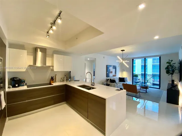 a kitchen that has a sink and a large counter top space