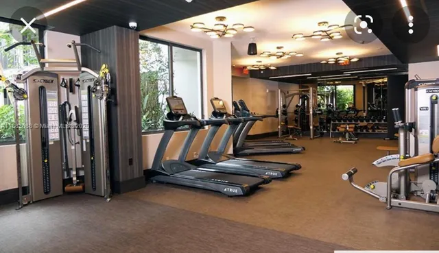 an empty room with gym equipment and a large window