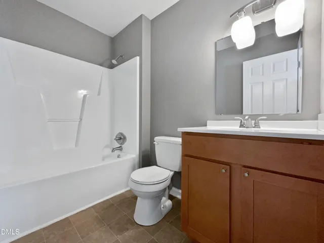 an empty room with windows and ceiling fan