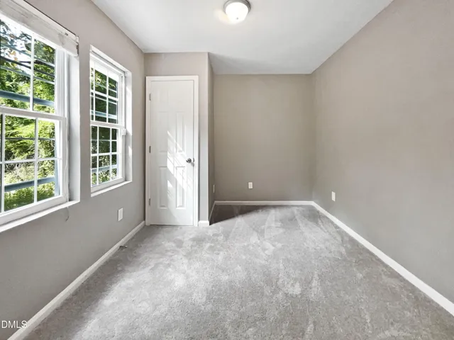a bedroom with a balcony a bed and a flat screen tv