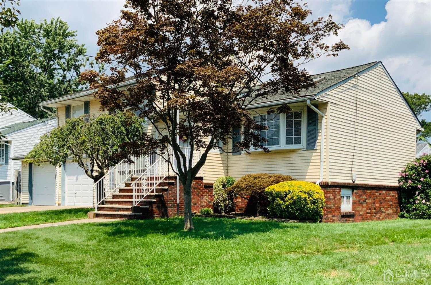 a front view of a house with a garden
