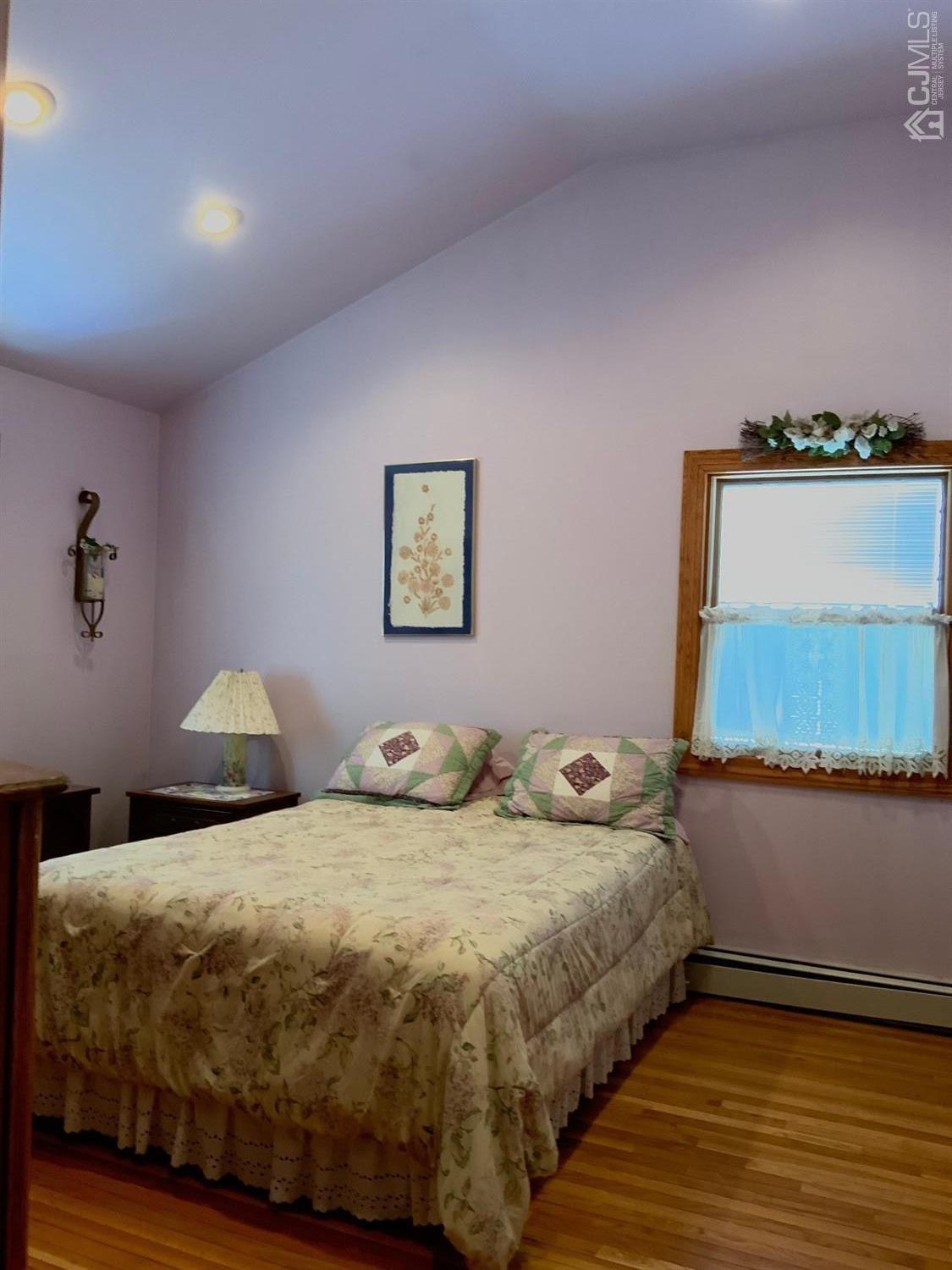 25 Penn Street Fords, NJ 08863 - Photo 13 of 20 a bedroom with a bed and painting on the wall
