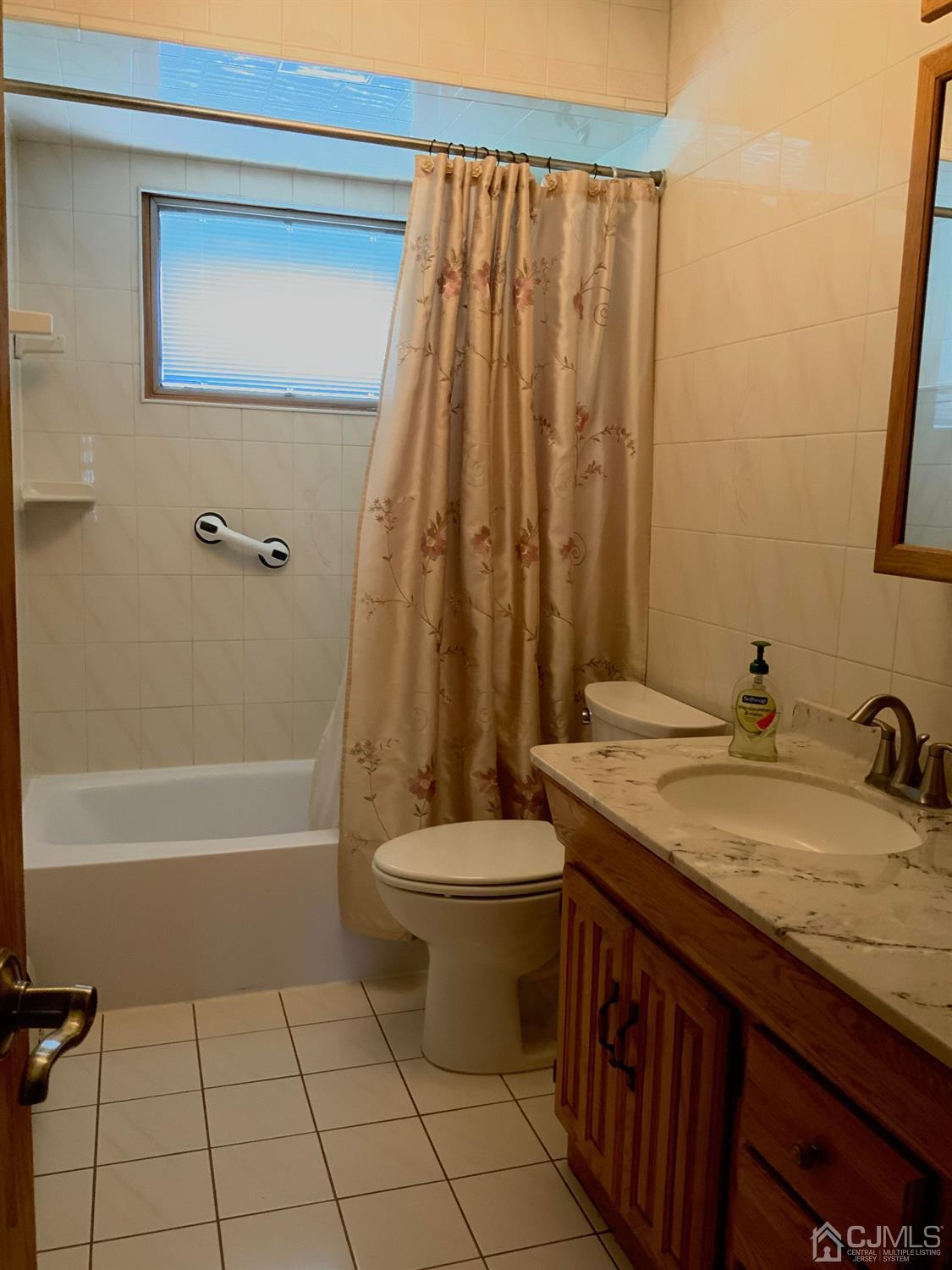 25 Penn Street Fords, NJ 08863 - Photo 15 of 20 a bathroom with a granite countertop sink and a mirror