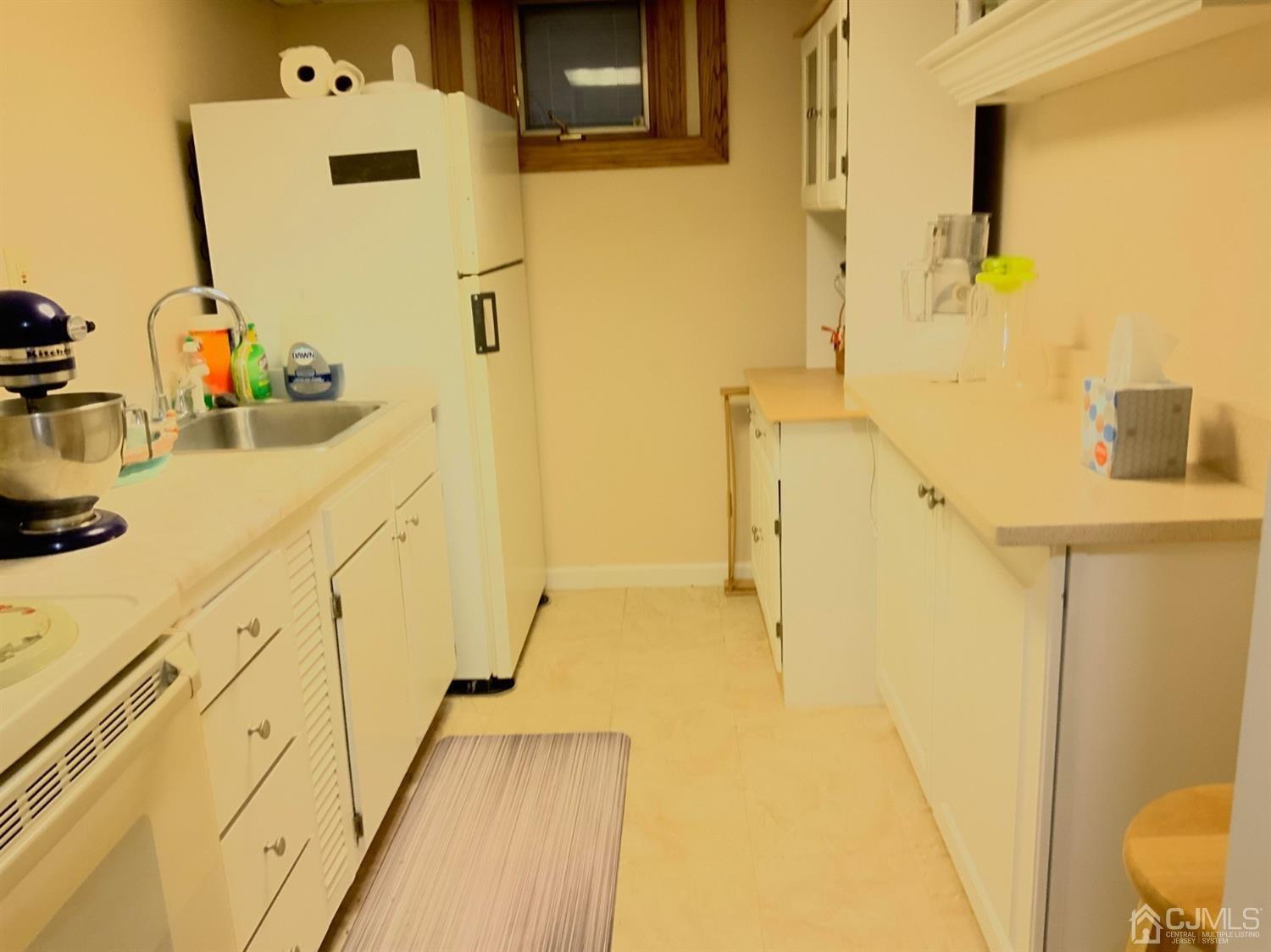 25 Penn Street Fords, NJ 08863 - Photo 19 of 20 a bathroom with a sink mirror toilet and shower