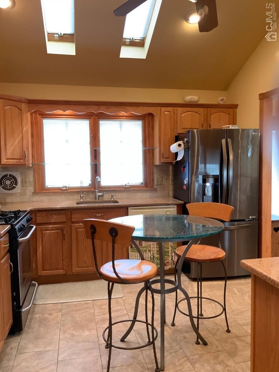 25 Penn Street Fords, NJ 08863 - Photo 8 of 20 a kitchen with stainless steel appliances kitchen island granite countertop a table chairs in it and wooden floors