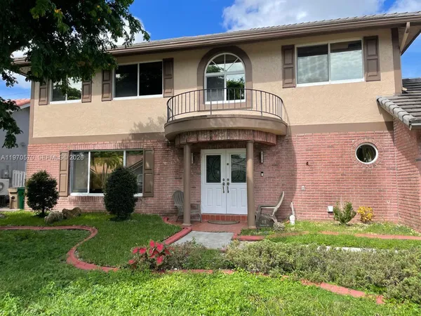 a front view of a house with garden